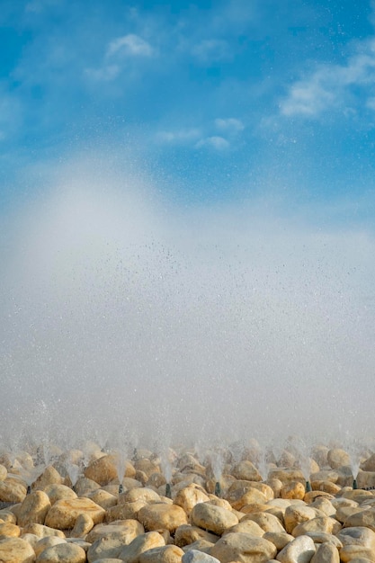 Fountain splashing jets against blue sky Alicante Spain