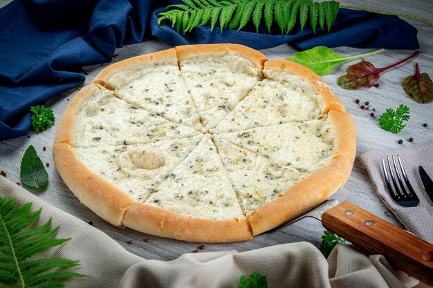 Four cheese pizza on a shovel Freshly baked with cream sauce parmesan gouda mozzarella and dor blue