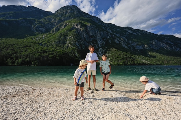 Four children in Lake Bohinj the largest lake in Slovenia part of Triglav National Park