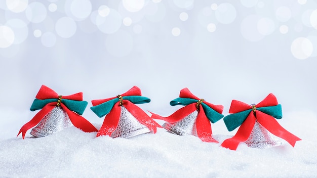 Four christmas bells in the snow