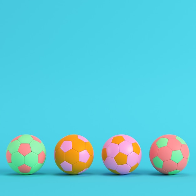 Four colorful soccer balls on bright blue background