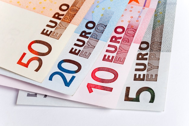 Four different euro banknotes lie on each other