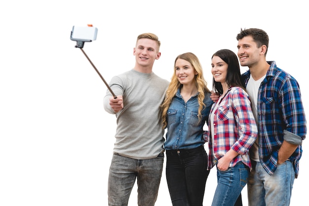 The four friends make a selfie on the white background