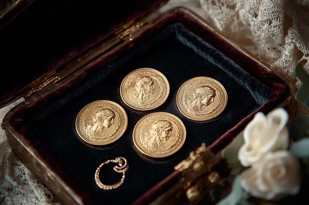 Photo four gold coins in a box with the number 3 on the top