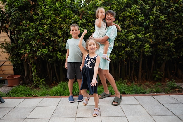 Four happy kids on the terrace of the house Brothers and sisters