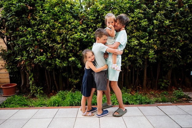 Four happy kids on the terrace of the house Brothers and sisters