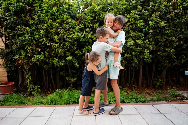 Four happy kids on the terrace of the house Brothers and sisters