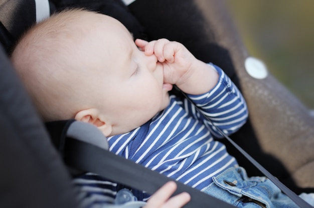 Four month old baby sucking his thumb and sleeping