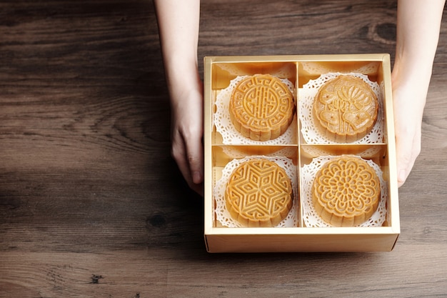 Four mooncakes with various fillings in box packed for mid fall festival