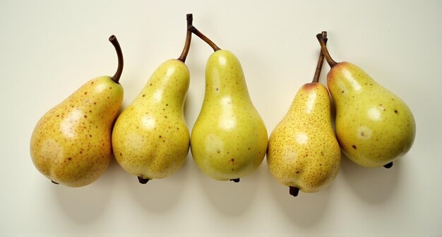 Photo four pears hanging on a wall one of which has a few stems