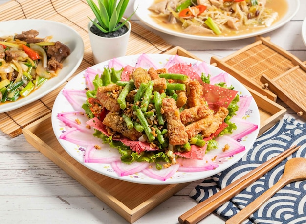 Four Seasons fried Fat Sausage served in a dish isolated on wooden tray and napkin side view of taiwan food