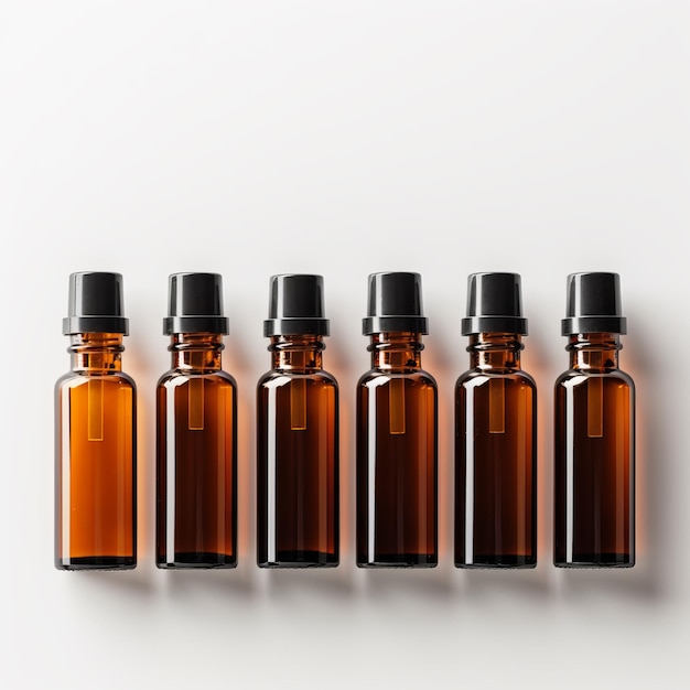 Photo four small bottles of brown liquid are lined up on a white background