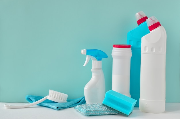 Four white bottles of household chemicals