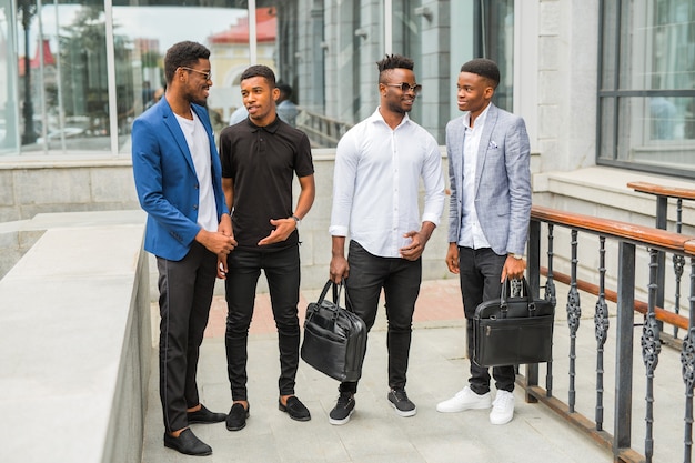 Four young African men near the building