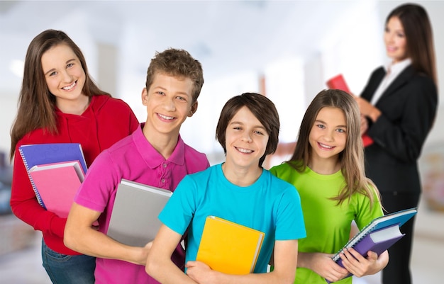 Four young cute kids in colored clothes with teacher