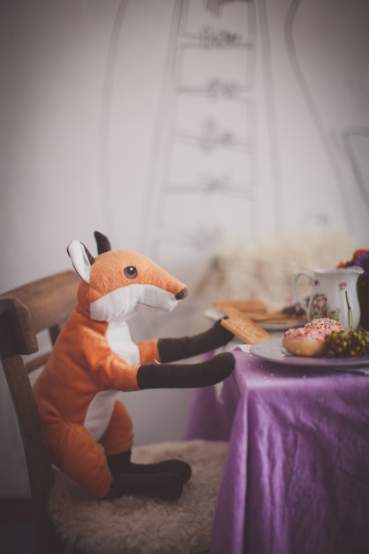 Fox soft toy seating at the table