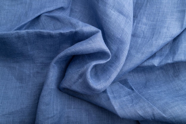 Fragment of blue linen tissue Top view natural textile background