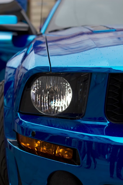 Fragment of blue sport car with with rain drops