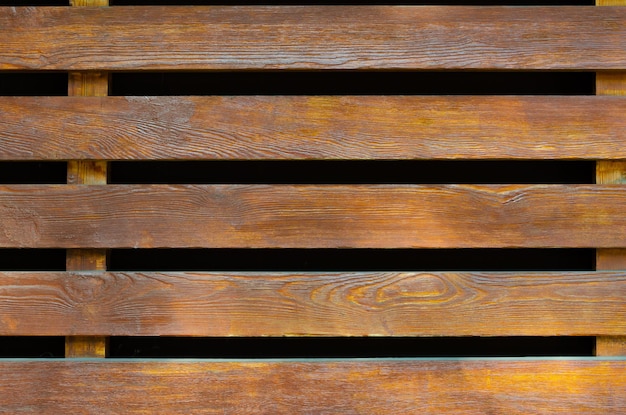 A fragment of a fence made of horizontal boards.