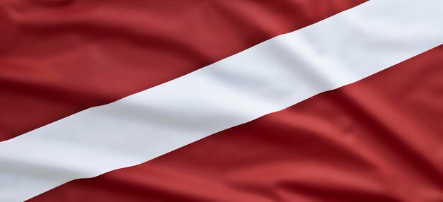 Fragment of the flag of Latvia closeup Carmine red with a white stripe Copy space