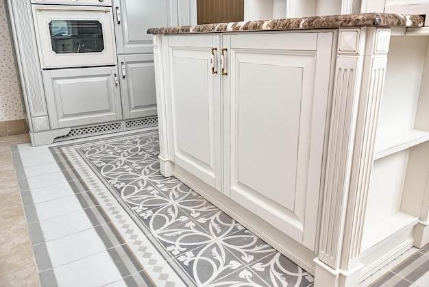 Fragment of kitchen island in country style with granite countertop closeup