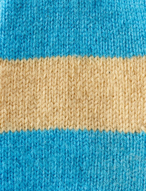 Fragment of knitted fabric from blue and beige wool