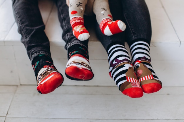 Fragment of a leg in Christmas socks three family copy space