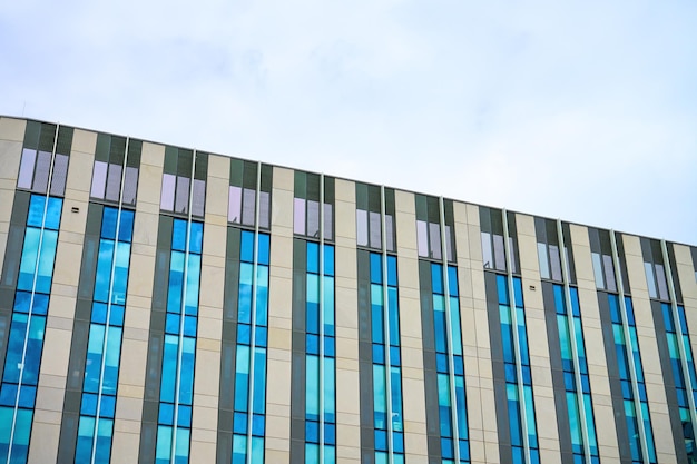 Fragment of modern building with glass facade detail of skyscraper business office windows in high r