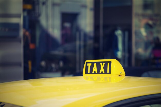 Photo fragment of one yellow car of the taxi with the sign or with a symbol closeup