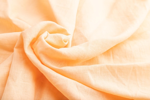 Fragment of orange linen tissue Side view natural textile background