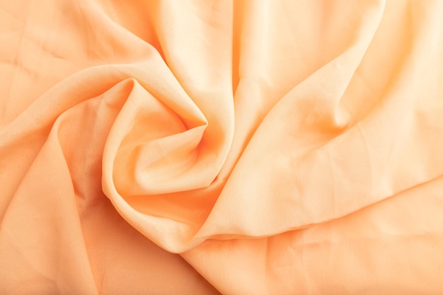 Fragment of orange linen tissue Top view natural textile background