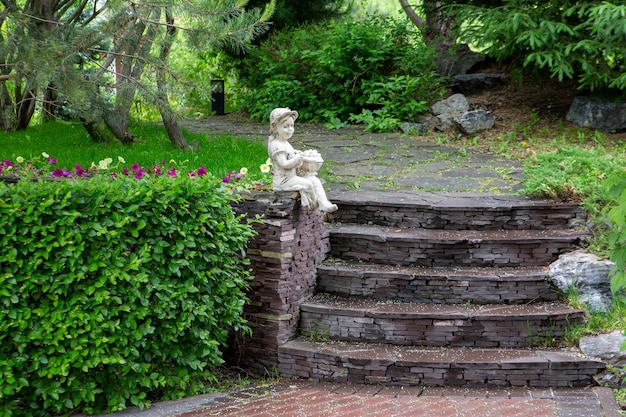 Fragment of the park with garden sculpture and plants A place for relaxation in a big city Landscaping