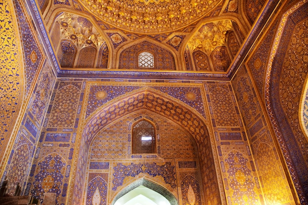 Fragment of a richly decorated wall inside the Sherdor Madrasah on Registan Square in Samarkand. 29.04.2019