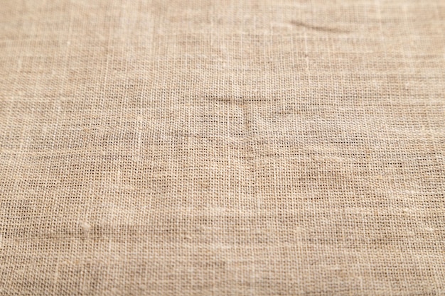 Fragment of rough linen tissue Side view natural textile background