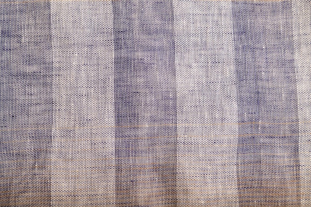 Fragment of smooth brown and violet linen tissue Top view natural textile background