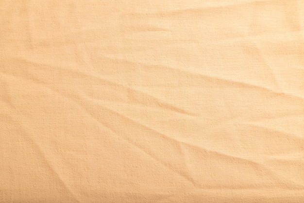 Fragment of smooth orange linen tissue Top view natural textile background