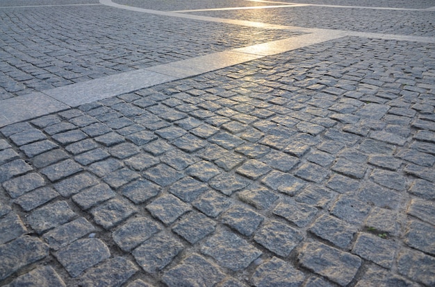 Photo fragment of the street square, folded out of a gray square paving stone