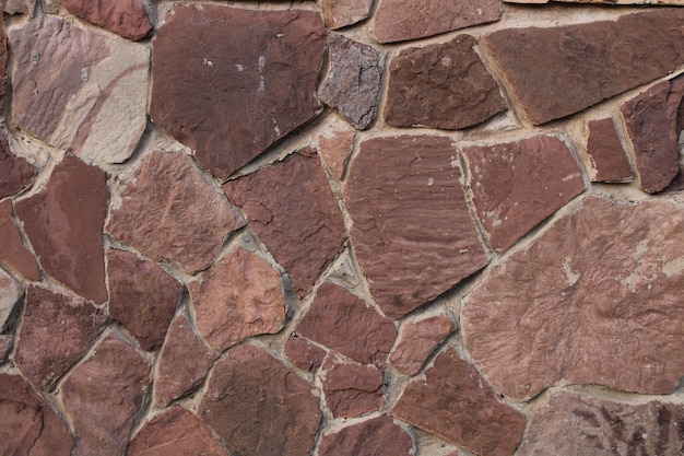 Fragment of a wall made of brown chipped stone