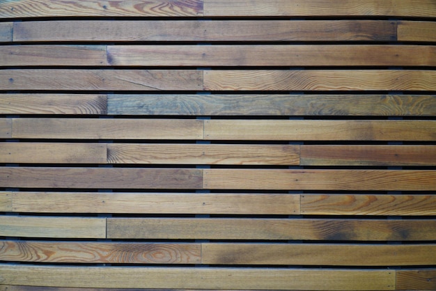 A fragment of a wall made of wooden clapboard