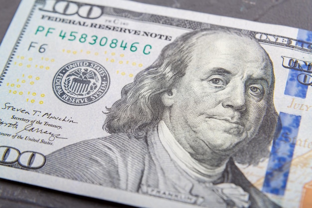 Fragments of dollar bills with a protective strip on the surface, very close-up. Horizontal photo