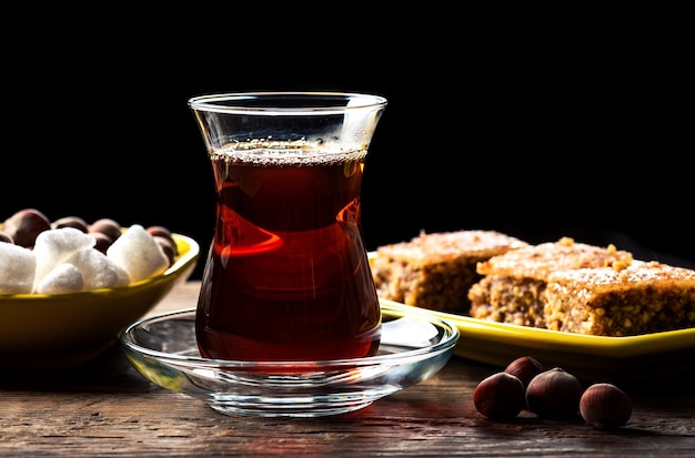 Fragrant black tea in a glass and with Shaki halva