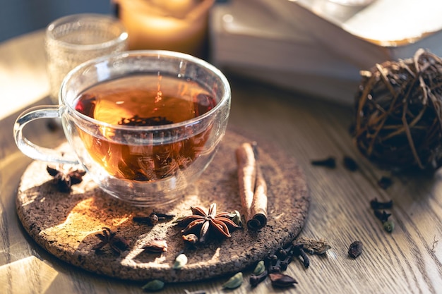 Fragrant hot tea with cinnamon on a wooden table