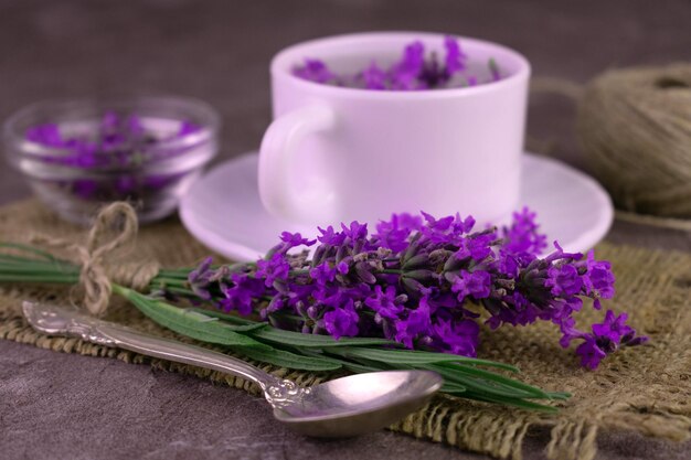 Fragrant lavender tea in a cup bouquet of fresh lavender flowers.Close-up.