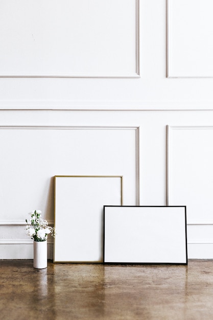 Frame against a white wall by a vase of flowers