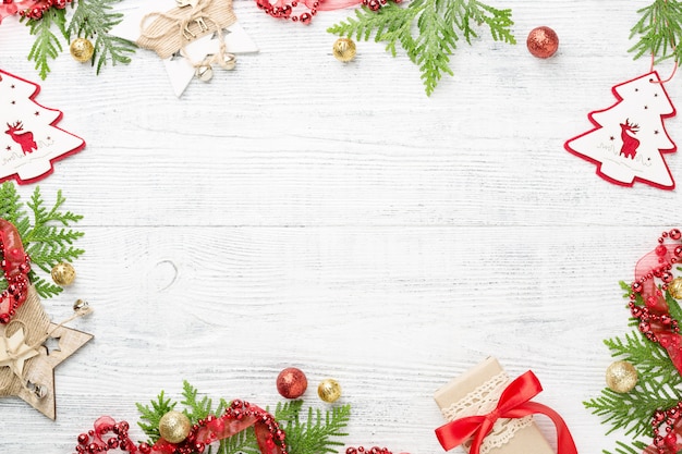 Frame of Christmas decorations on white table