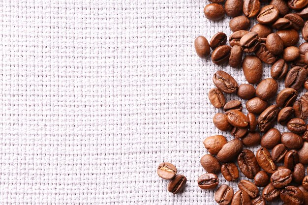 Frame of coffee beans on sackcloth background