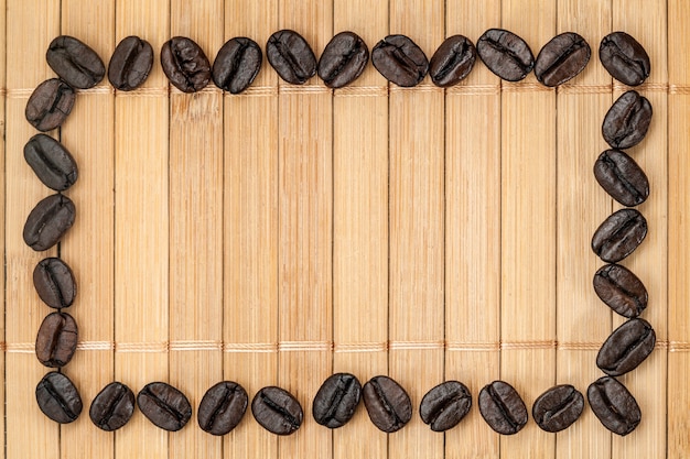 Frame of coffee grains on a bamboo napkin