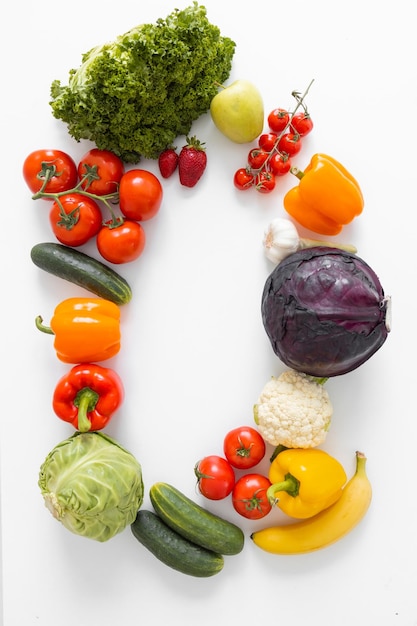 Frame of fresh vegetables and fruits isolated on white background