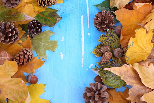 Frame from autumn leaves on wooden table closeup