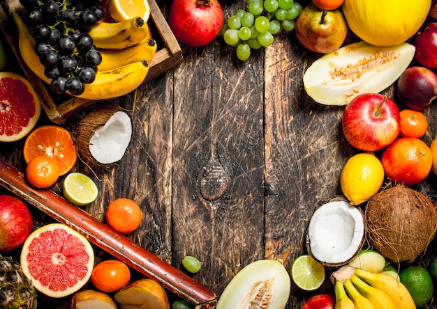 Frame from fresh fruits. On wooden Background.